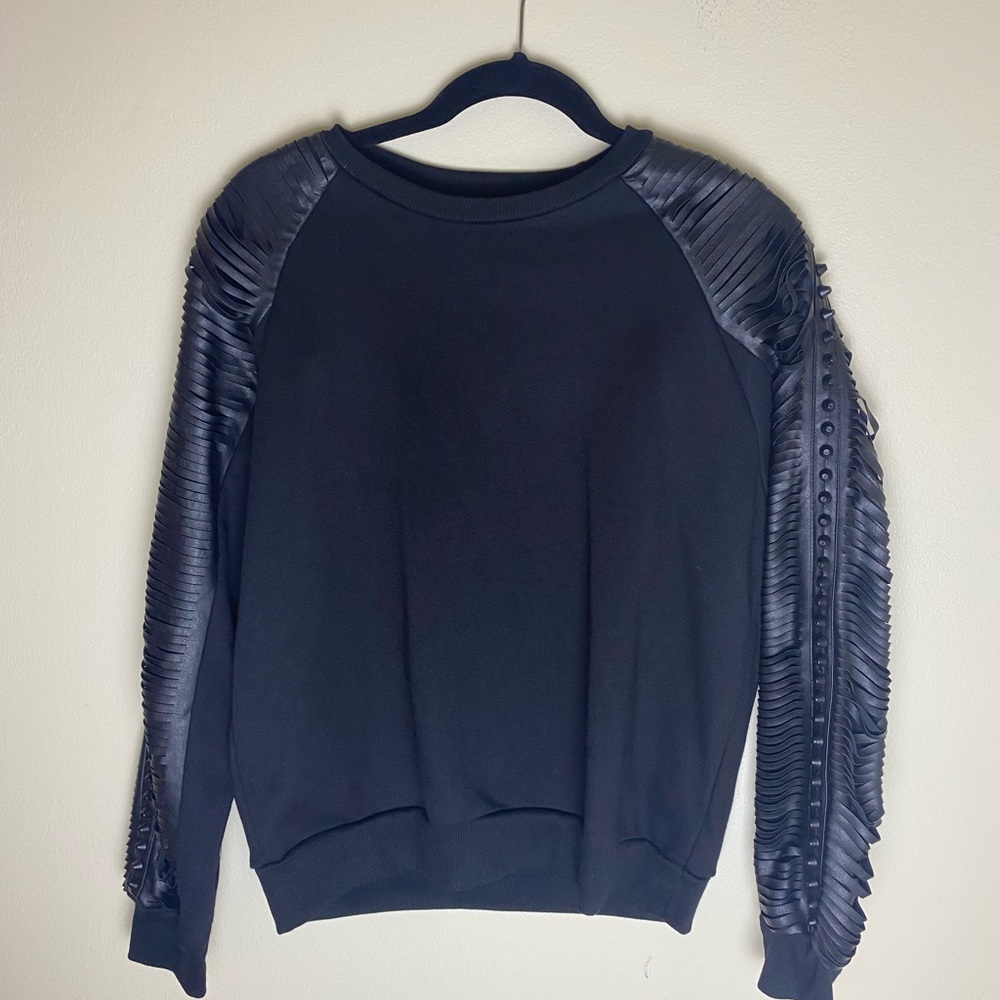 Navie women’s cut up faux leather sleeve pullover in black. Dress up or down.